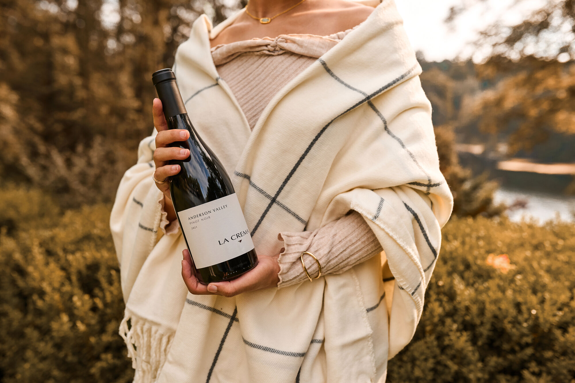 A women holding a bottle of La Crema Pinot Noir